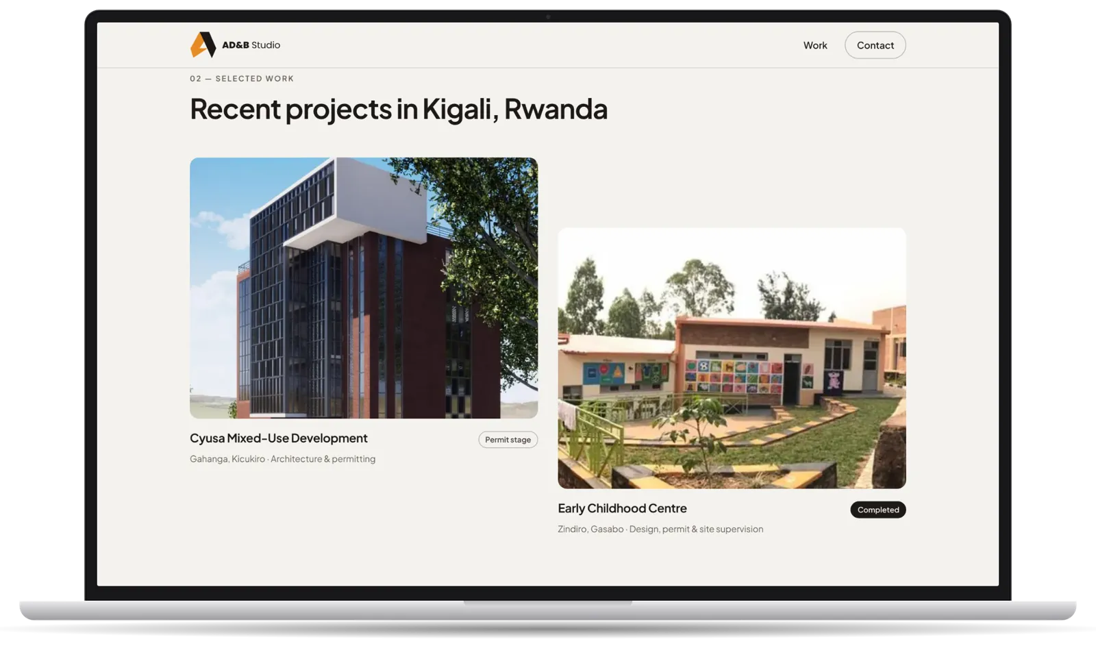 Laptop showing the selected-work section with project photos from Kigali.